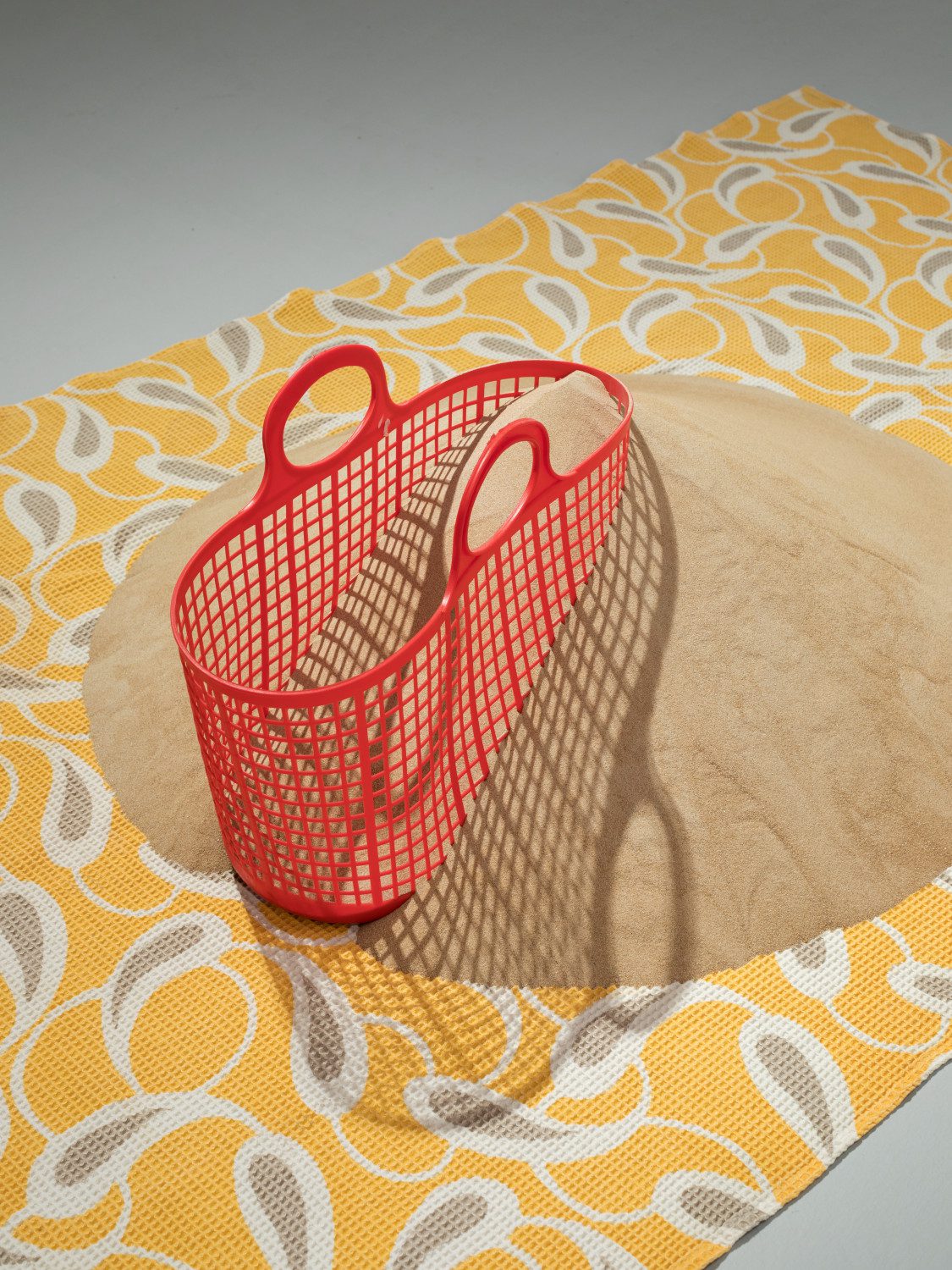 Sand upon Sand, 2009, fabric blanket, plastic basket, and sand, 40 x 180 x 90